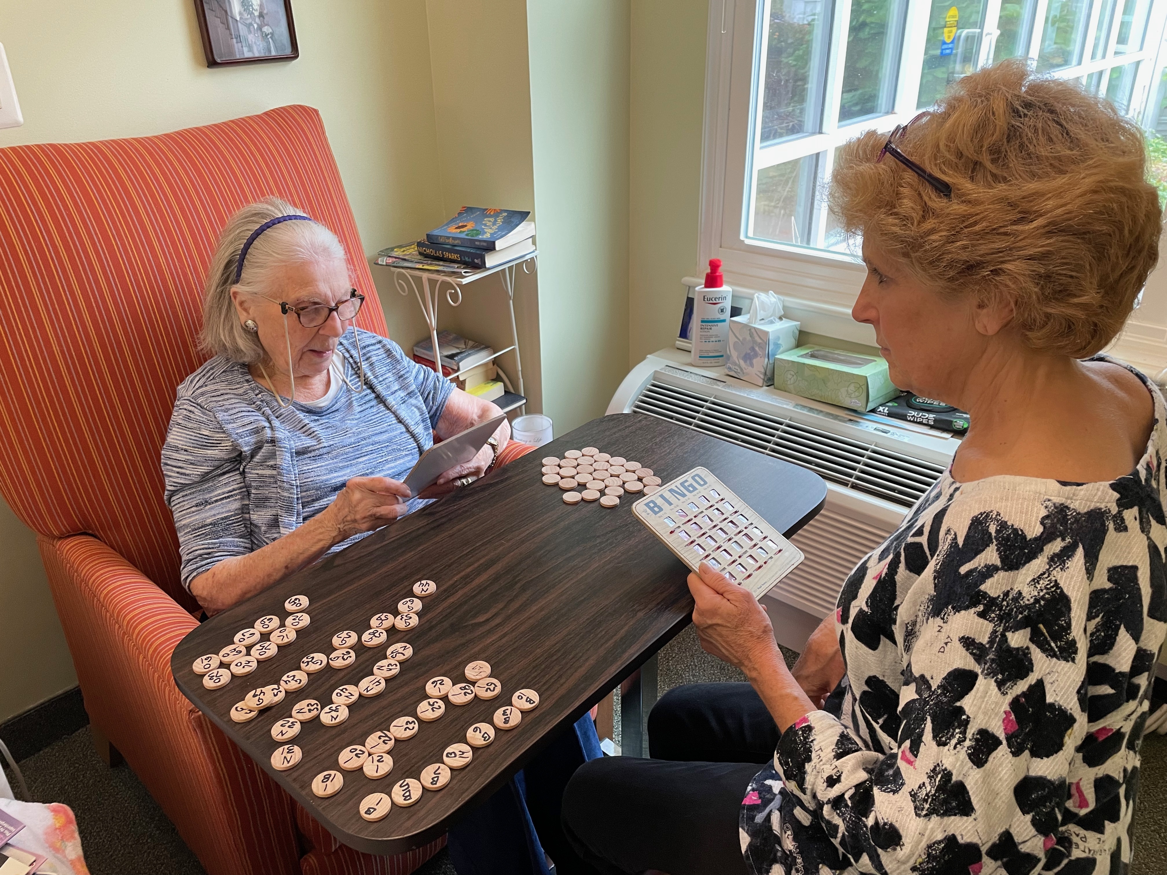 Rita Orr, 94, and her daughter Janice Rogers sit across a small table from each other to play Bingo.